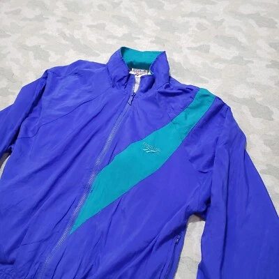 Chaqueta cortavientos Reebok vintage para mujer azul medio cremallera completa cuello falso Foto 1 de 4