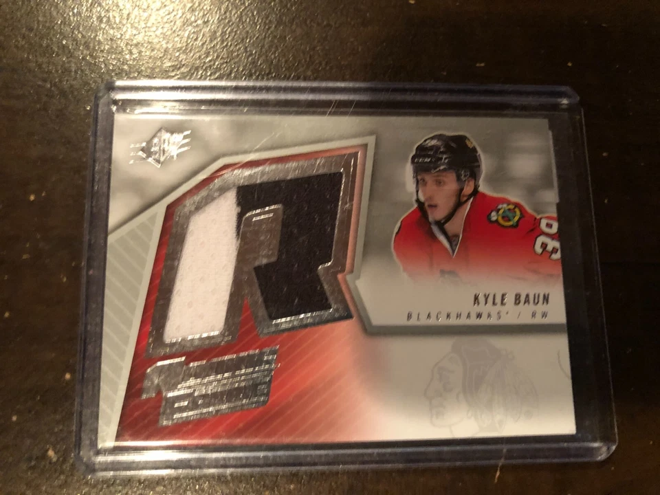 2015-16 SPX Rookie Jersey (05-06 retro) KYLE BAUN #SPXR-KB 2 Colors 2CLR - Image 1 of 1