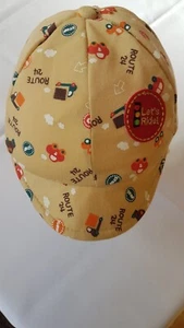 baby boy cap in beige. 45cm, car themed pics, little embroidered badge, lined - Picture 1 of 5