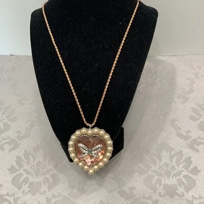 BETSEY JOHNSON LARGE HEART FAUX PEARLS AND BLING BOW/ ROSE GOLD COLORED NECKLACE - Image 1 of 4