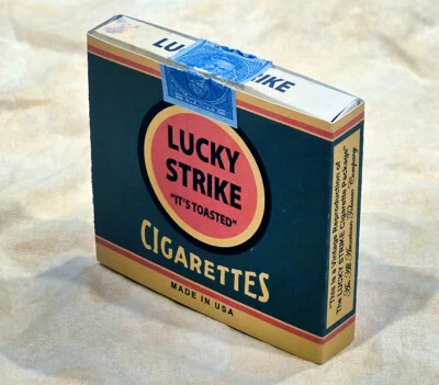 Lucky Strike It’s Toasted paquete de cigarrillos deslizantes caja sello de impuestos tabaco Foto 1 de 4