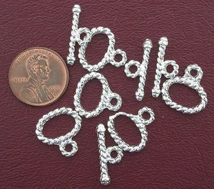 VIER 15x11 15 mm x 11 mm STERLING PLATTIERTE GEDREHTE OVALE KNEBELVERSCHLÜSSE AF2 - Bild 1 von 1