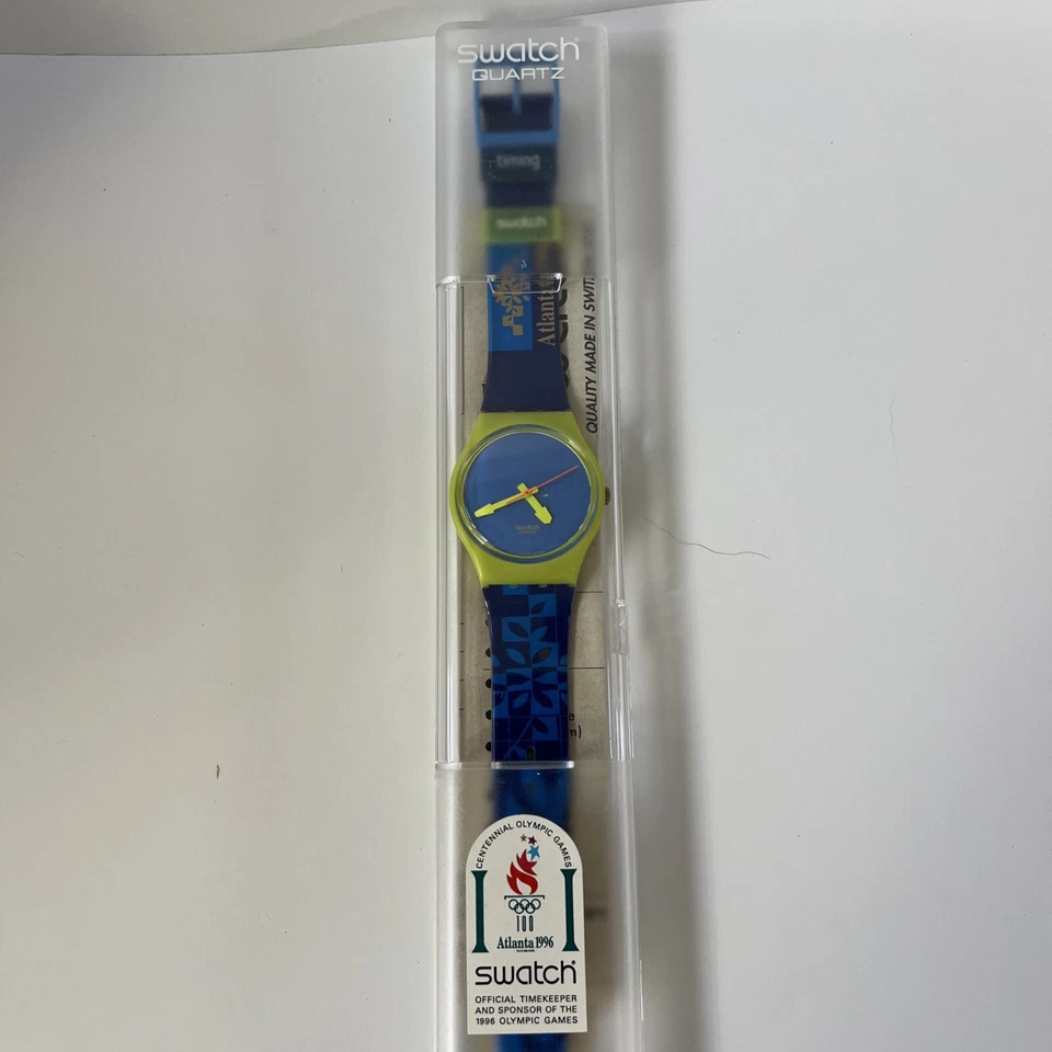 RELOJ MUESTRA ATLANTA 1996 OLÍMPICOS AZUL Y VERDE NUEVO Y PRECINTADO Foto 1 de 4