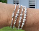 Silver Colour Roun Beads With Star Dust Beads Stretchable Bracelets(set of 4)
