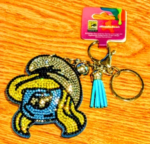 Bolso Pitufo Dije Llavero Pitufina Bling Comic Con 2025 Exclusivo Nickelodeon  - Imagen 1 de 4