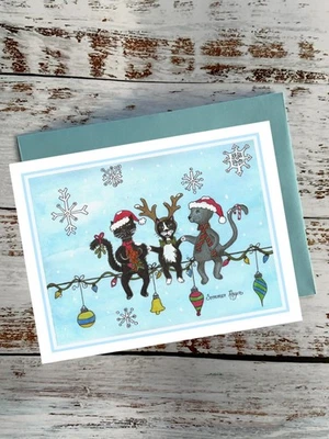 Happy cats sitting on Christmas lights, ornaments, snowflakes, notecard #422 - Image 1 of 2