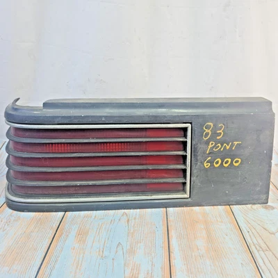 GM 16500342 Pontiac 1982-1983 6000 LH Driver Tail Light Assembly Dark Gray Trim - Image 1 of 4