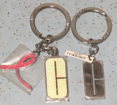 (2) CLINIQUE LETTER C CHARM KEYCHAINS & 1 BREAST CANCER AWARENESS CHARM - Image 1 of 4