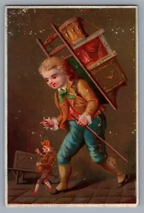 Carta commerciale vittoriana del 1800 bambino vittoriano con pupazzo, carta colorata Marionnette - Foto 1 di 2