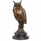 A bronze sculpture of a long-eared owl 30cm