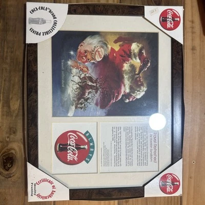 1998 Coca Cola Haddon Sundblom Travel Refreshed Santa & Sprite Boy Framed Print - Image 1 of 4