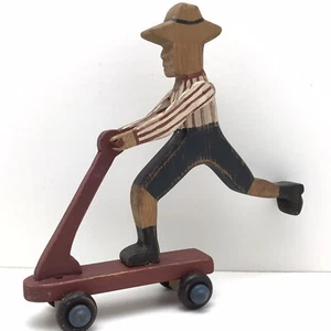 Folk Art Wooden Hand Painted Figurine Man on Scooter Rustic 7 1/2" - Picture 1 of 11