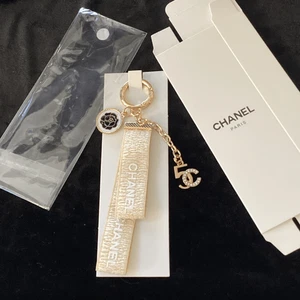Chanel NEW w/ Box GWP Cream Gold Ribbon Key Chain Bag Charm Rhinestones Rose - Picture 1 of 4
