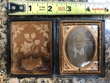 Antique daguerreotype of seated older woman in bonnet, in case