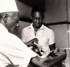 Football ca 1960 Brazil star Pele shows a keen interest as a chef OLD PHOTO