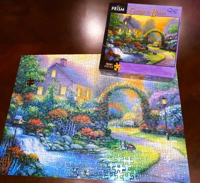 1000 piece Prism Puzzle Cottage in Bloom by John Zaccheo 2007 - Image 1 of 4