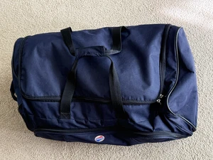 Bolso de Lona American Tourister Azul Marino con Ruedas 24" Bolsillos Laterales - Imagen 1 de 11