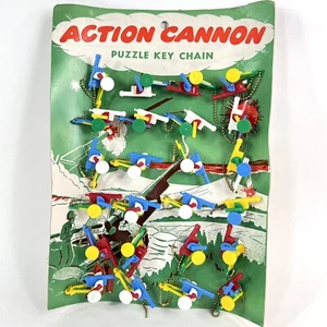 TRAUMHAFTER VINTAGE ACTION KANONE SCHLÜSSELANHÄNGER PUZZLE LADEN DISPLAY NEU UNBENUTZT MIT ETUI - Bild 1 von 7