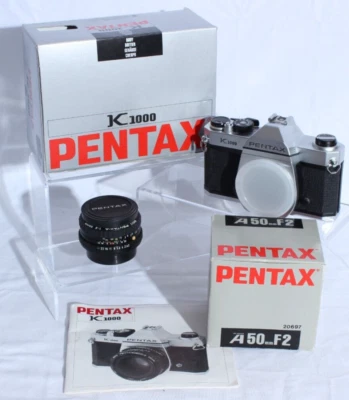 Paquete de cámara fotográfica SLR PENTAX K1000 en caja usada en excelente estado lente F2 de 50 mm Foto 1 de 4