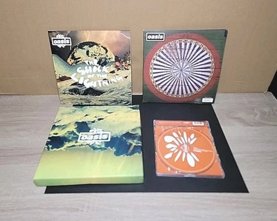 OASIS Stop The Clocks (2) Numbered 7" Vinyls + Shock Of The Lightning Vinyl & CD - Image 1 of 4
