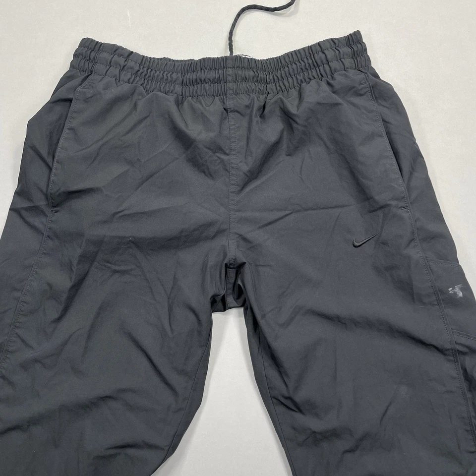 Pantalones cortavientos Nike de colección para hombre M pantalón de pista bolsillo negro atlético naranja etiqueta Foto 1 de 4