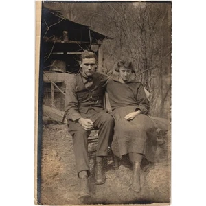 Vintage Photo Couple Sitting Outdoors Early 1900s Boots Vest Chain Rural - Picture 1 of 2