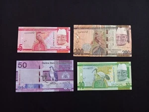 GAMBIA 5 + 10 + 50 + 200 DALASIS Banknotes - Circulated / Damaged - Picture 1 of 2