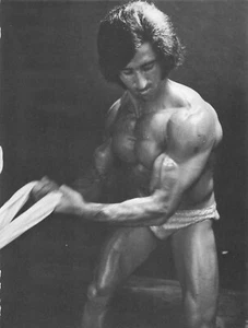 Bodybuilder 1970s Hair Flexes his Muscles - Picture 1 of 1