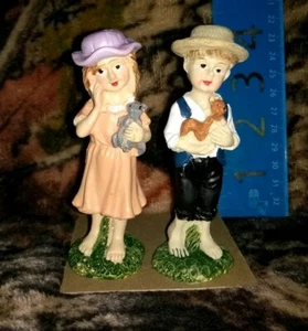 young girl with hat holding teddy bear & young boy holding squirrel MINI GARDEN - Picture 1 of 2