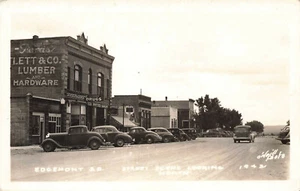 Edgemont SD Street Scene Looking North Storefronts Cars Lumber & Hardware RPPC - Picture 1 of 2