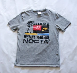 Men's Nike NOCTA Distant Regards Turks & Caicos CPFM Grey Graphic Print T Shirt - Bild 1 von 9