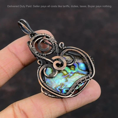 Oferta de Año Nuevo Cobre Ovalado Abulón Concha Piedras Preciosas Esposa Boho Alambre Envuelto Colgante Foto 1 de 4