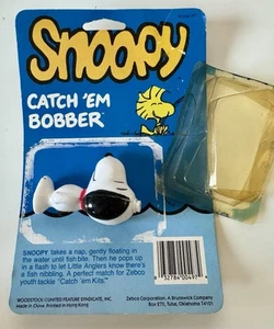 Bobber da pesca vintage Snoopy Catch Em Zebco nuovo vecchio magazzino scatola aperta - Foto 1 di 8