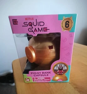 YuMe Squid Game Sparschwein Kapsel, Squid Game Masked Manager Figur - Bild 1 von 7