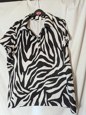 Top de golf Chico's Zenergy talla 2 negro + blanco estampado de cebra P2P 21" Foto 1 de 4