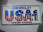 NOS Small hole USA-1 U.S.A.-1 Chevrolet GM Dealer License Plate Taking Charge! Chevrolet Chevelle
