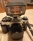 Canon 35mm AE-1 Program, Flash, 50mm Lens, Strap And Instruction Book.