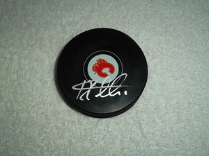 Jonas Hiller Hand Signed Calgary Flames Logo Puck NHL Autograph Signature Hockey - Picture 1 of 2