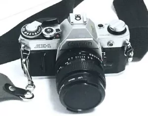 Canon AE-1 fotocamera reflex pellicola - nero/argento. obiettivo 35 mm,50 mm f/1.8 con istruzioni - Foto 1 di 12