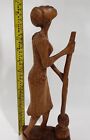 African women wood sculpture with broom