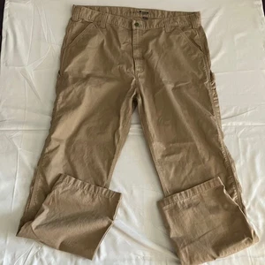 Pantalones de trabajo utilitarios Carhartt calce relajado para hombre 42x34 caqui tostado carpintero - Imagen 1 de 8