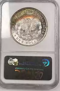 1885O MORGAN DOLLAR /1/4 MOON RAINBOW TONED REV /NICE LUSTER BOTH SIDES/NGC MS63 - Picture 1 of 3