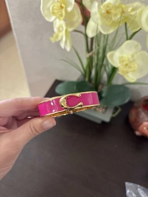 pulsera coach oro mujer rosa Foto 1 de 3