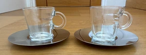 2 x NESPRESSO VIEW ESPRESSO TEMPERED GLASS CUPS & STAINLESS STEEL SAUCERS - Picture 1 of 11