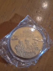 2011 Commemorative Coin - “You Can Run But You Cant Hide" Gold Colored Sealed - Imagen 1 de 2