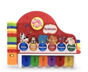 Small World Toys Neurosmith Musical Library Piano-Shaped Electronic Book - Picture 1 of 7