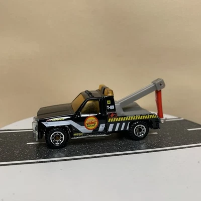 Grúa de servicio Matchbox GMC 1987 grúa negra/blanca a rayas 1:64 casi nueva Foto 1 de 4