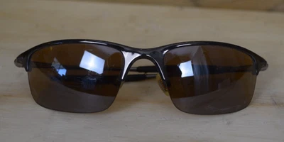 Gafas de sol Oakley polarizadas con lentes marrones deportivas envolventes medio cable medio borde envolvente Foto 1 de 4