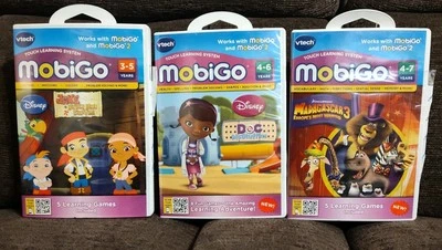 Lot 3 VTech MobiGo Games Jake The Neverland Pirates Doc Mcstuffins Madagascar 3 - Image 1 of 4