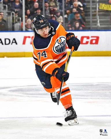 Ethan Bear Edmonton Oilers Unsigned Orange Jersey Shooting Photo Cover